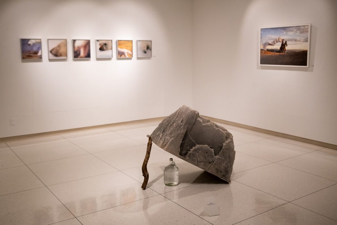 piece of art displaying a rock over a bottle